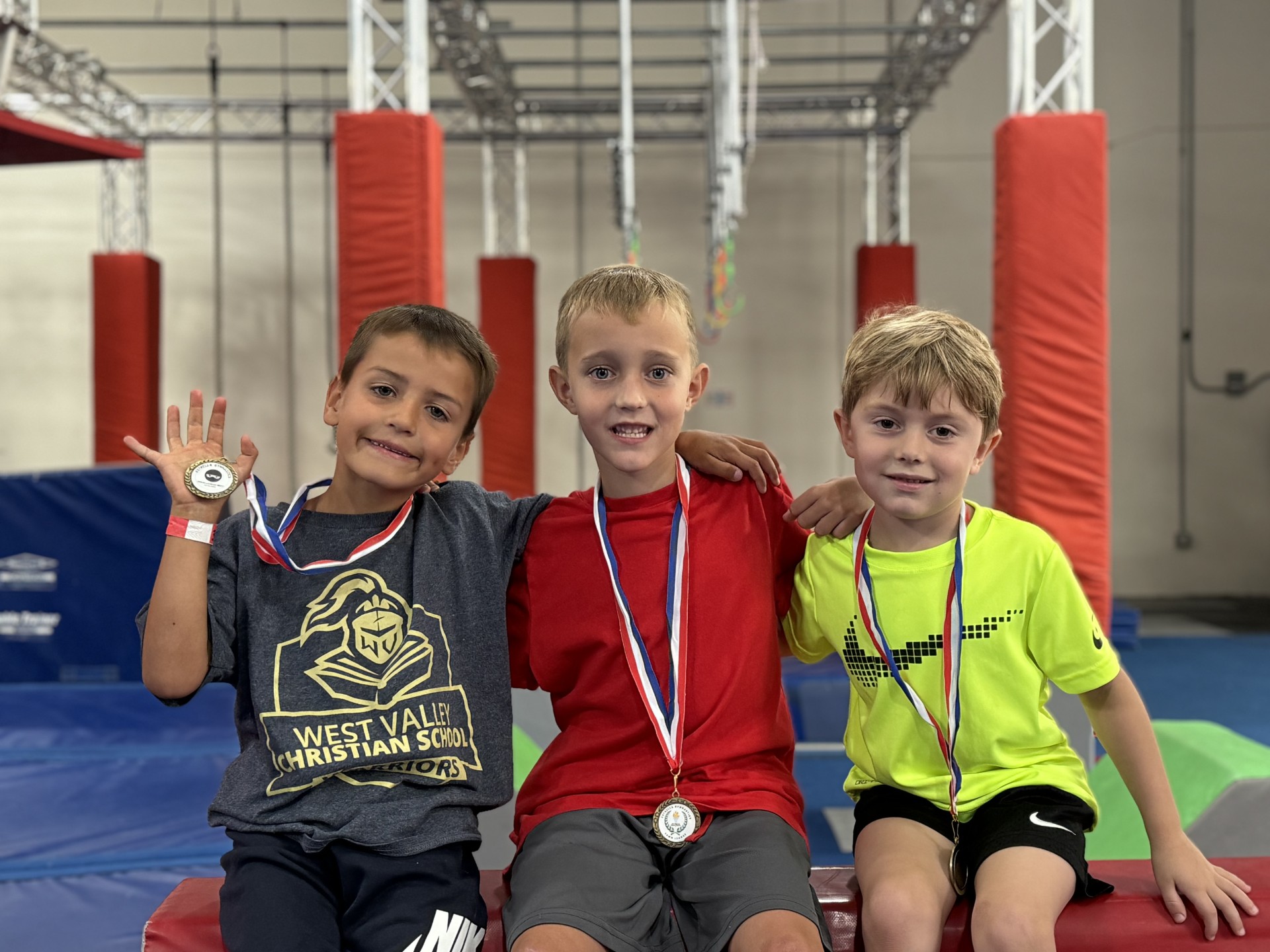 Kid swinging on ninja warrior rings